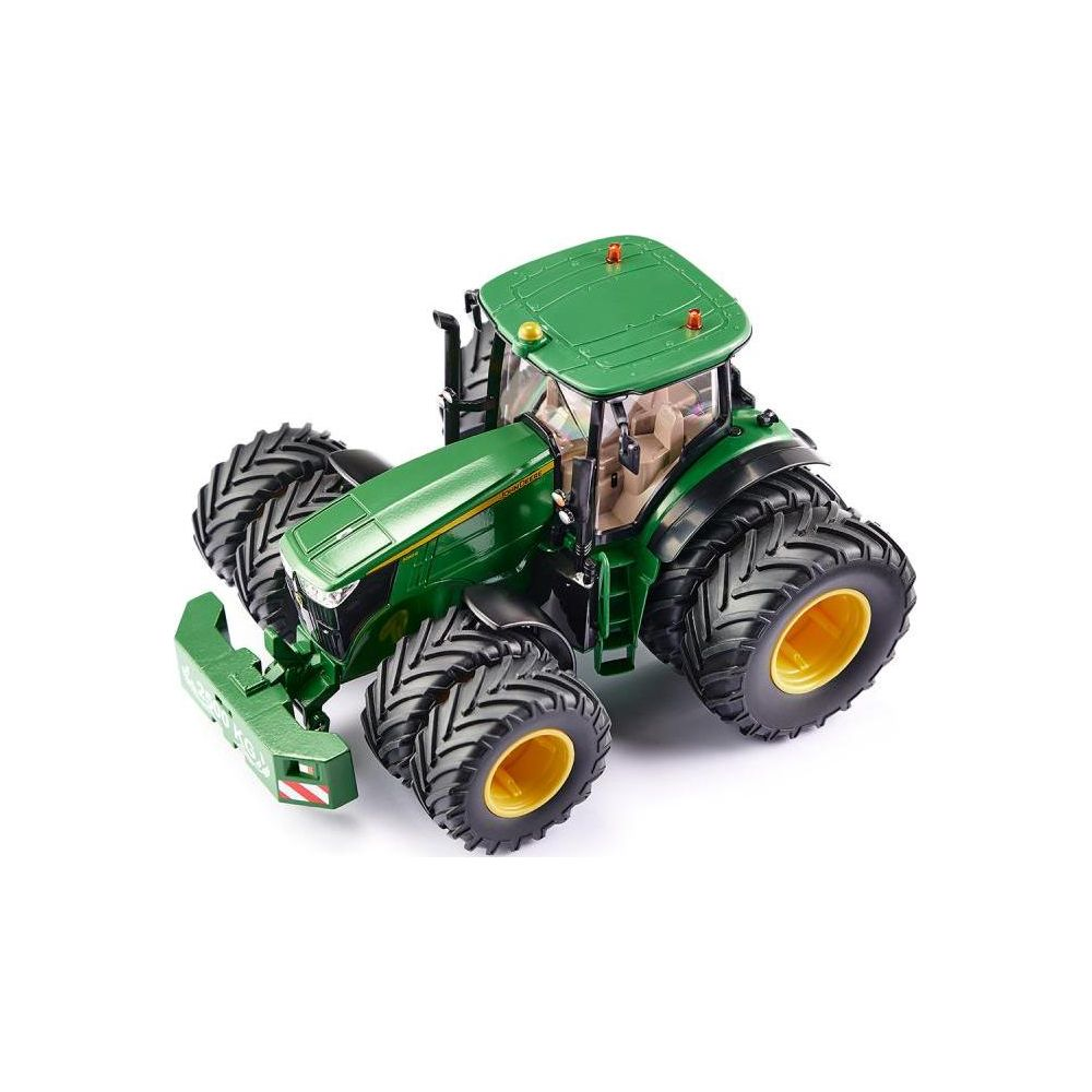 Un tractor de juguete verde con neumáticos grandes y llantas amarillas.