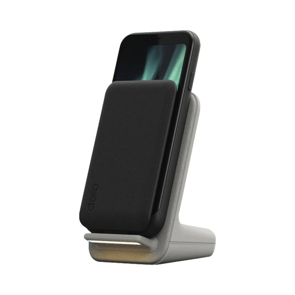 Ein Smartphone lädt auf einer grauen Ladestation mit schwarzem Akku.