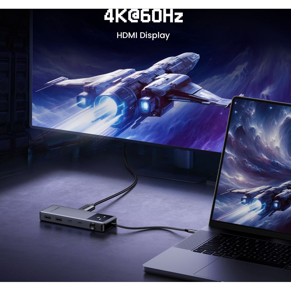 Laptop połączony przez hub z dużym ekranem wyświetlającym statek kosmiczny.