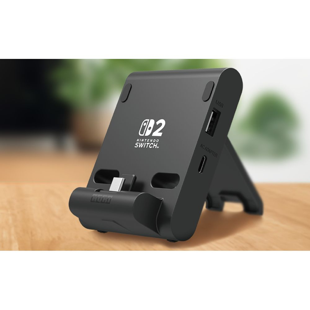Supporto nero Nintendo Switch con porte USB e adattatore AC.
