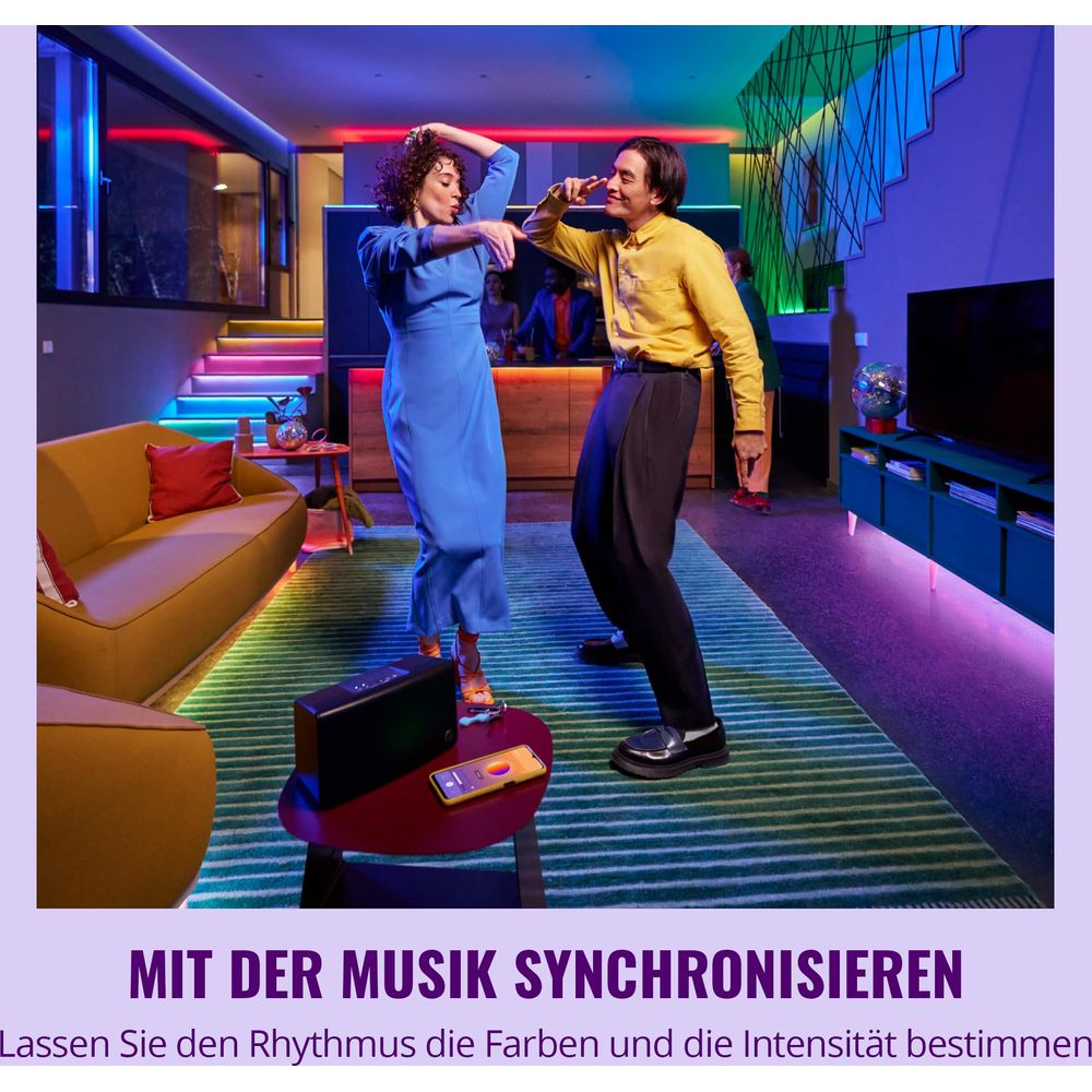 A couple dances in a room with colorful lighting, synchronized to music.