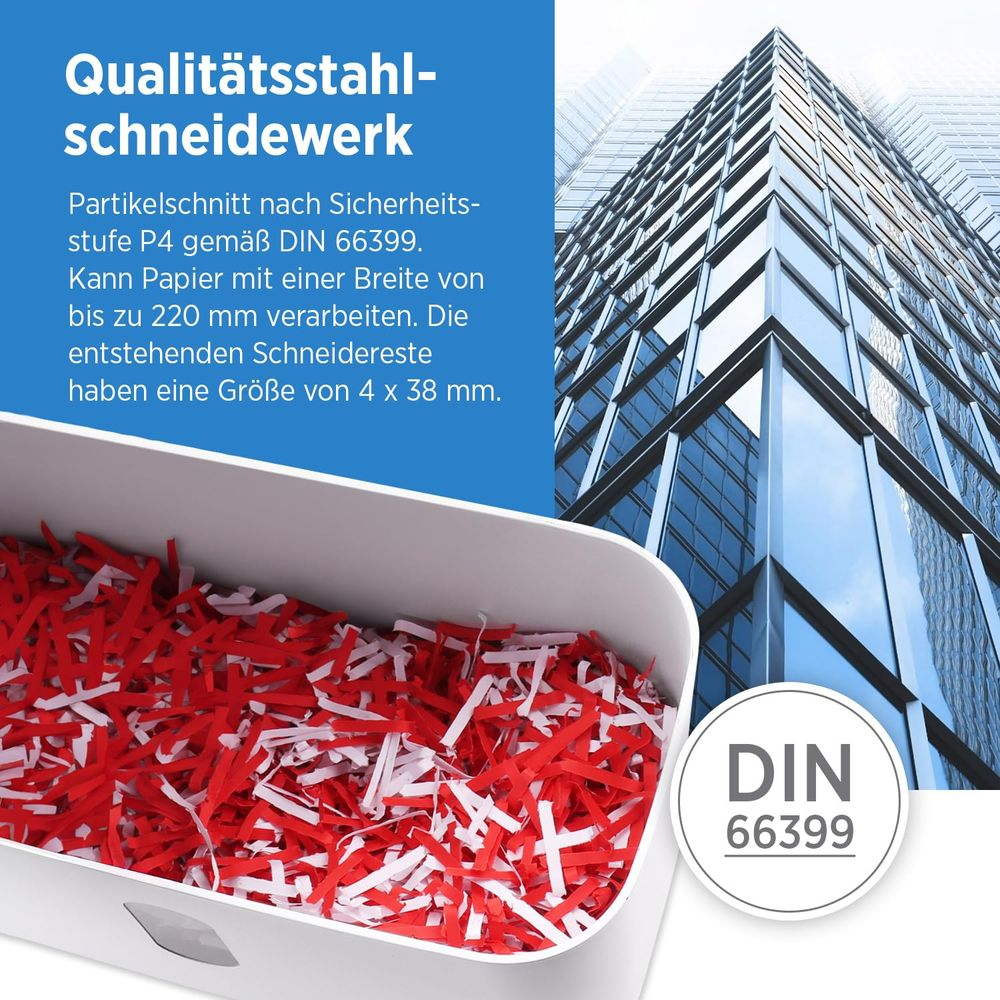 Kosz na papier z czerwonymi i białymi skrawkami. Wieżowiec w tle.