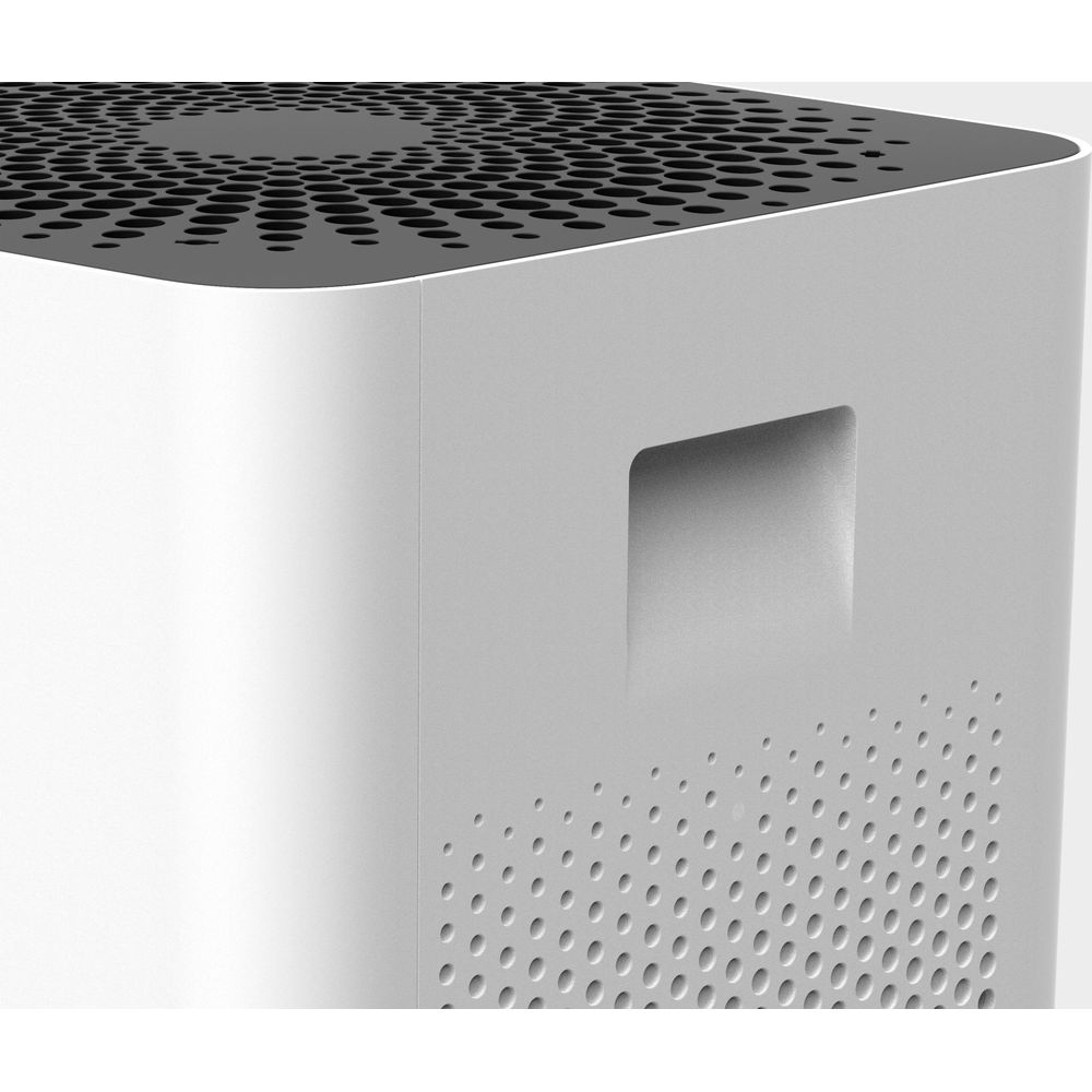 Biały wierzch oczyszczacza powietrza z kratką wentylacyjną i uchwytem.