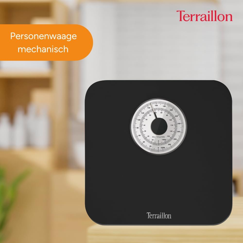 Czarna mechaniczna waga Terraillon z białym cyferblatem pokazującym wagę w kg i funtach.