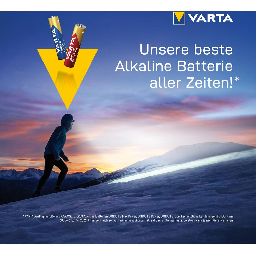 Due batterie Varta sopra una persona che corre su una collina innevata al tramonto.