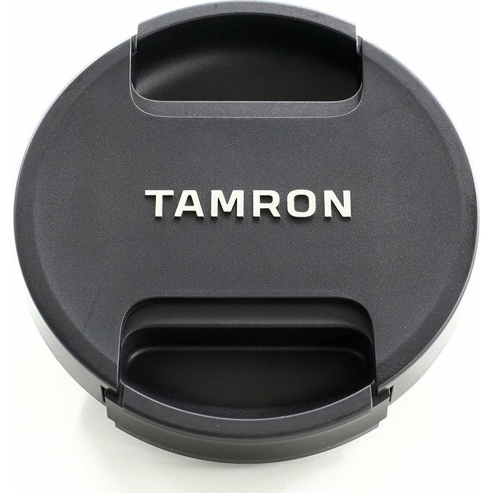 Bouchon d'objectif noir avec logo Tamron argenté et encoches.