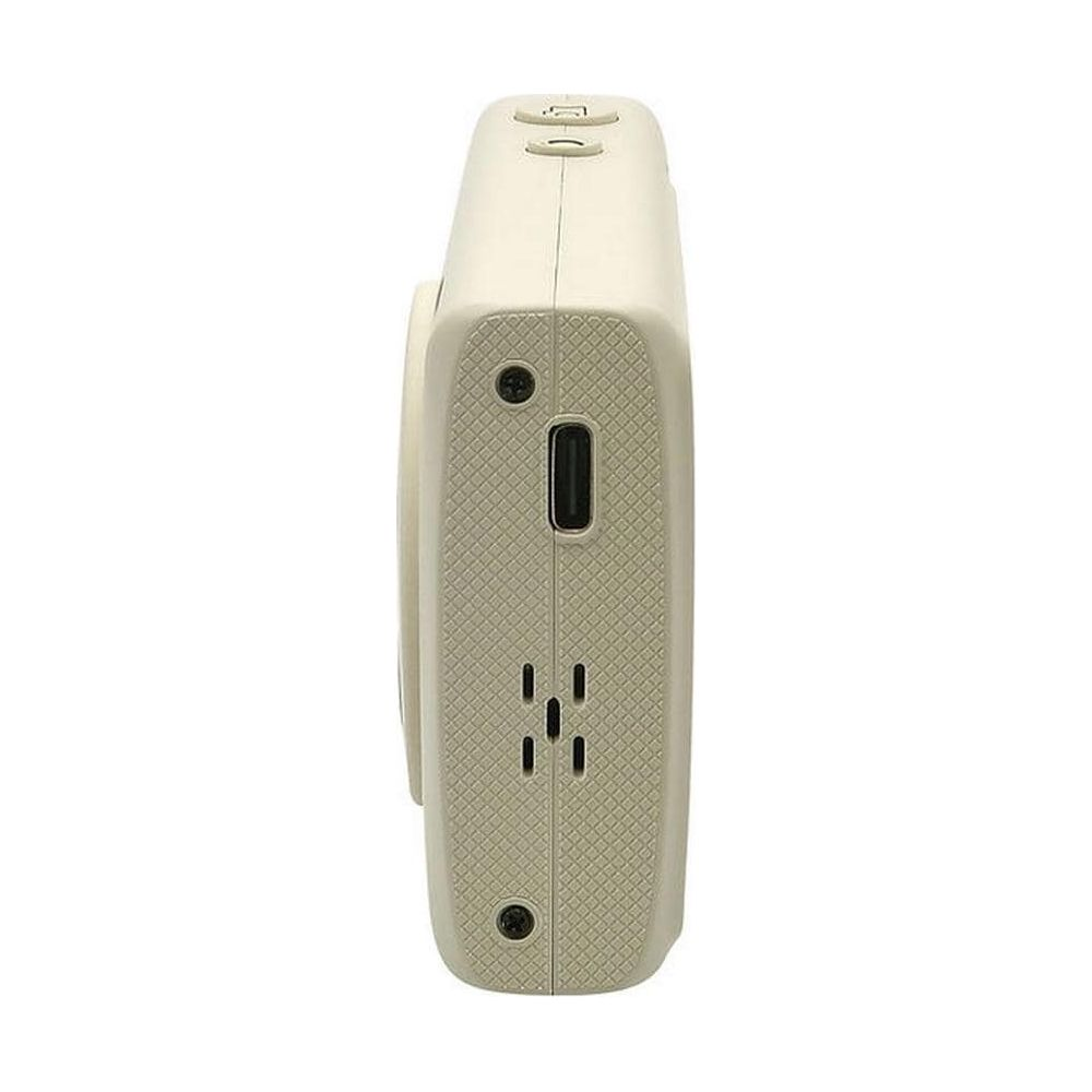 Cámara beige con puerto USB y dos botones en la parte superior.