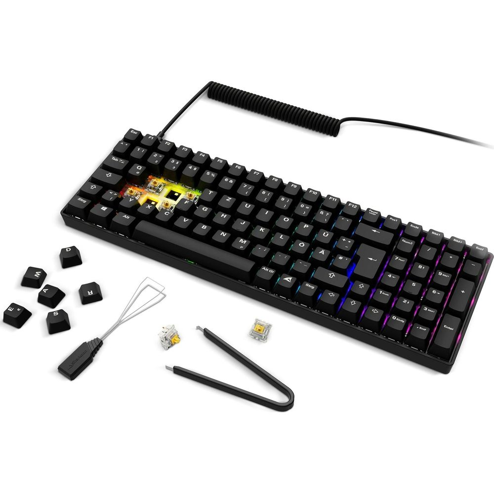 Tastiera nera con tasti RGB colorati, attrezzi e copritasti separati.