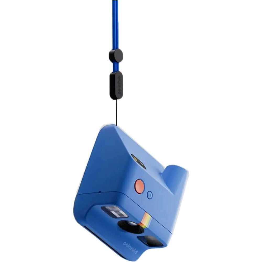 Cámara instantánea azul con detalle de raya de arcoíris y cordón.