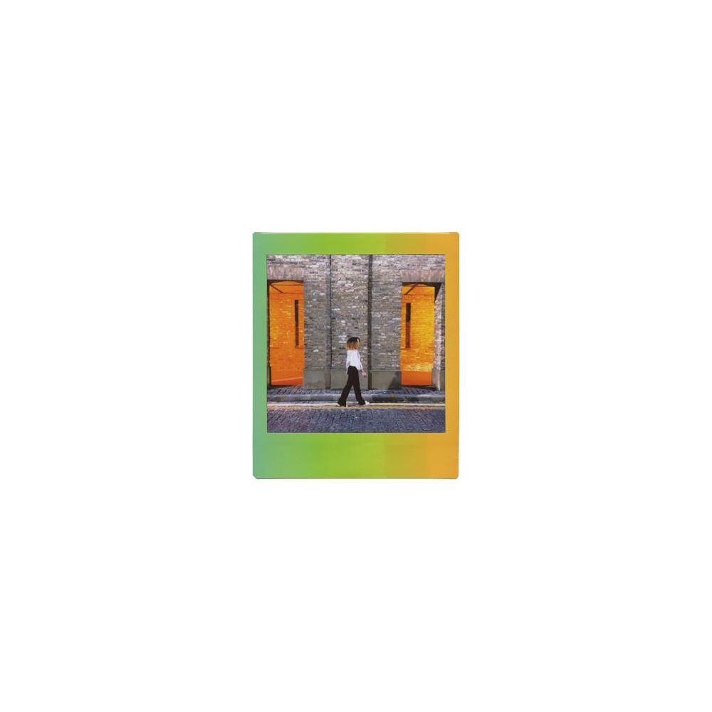 A person walks on a cobblestone path between two orange doors.