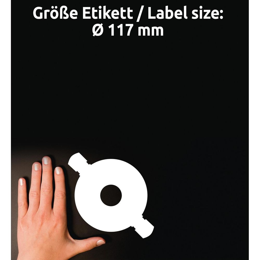 Eine Hand vergleicht die Größe eines weißen runden Objekts mit zwei seitlichen Ausläufern.