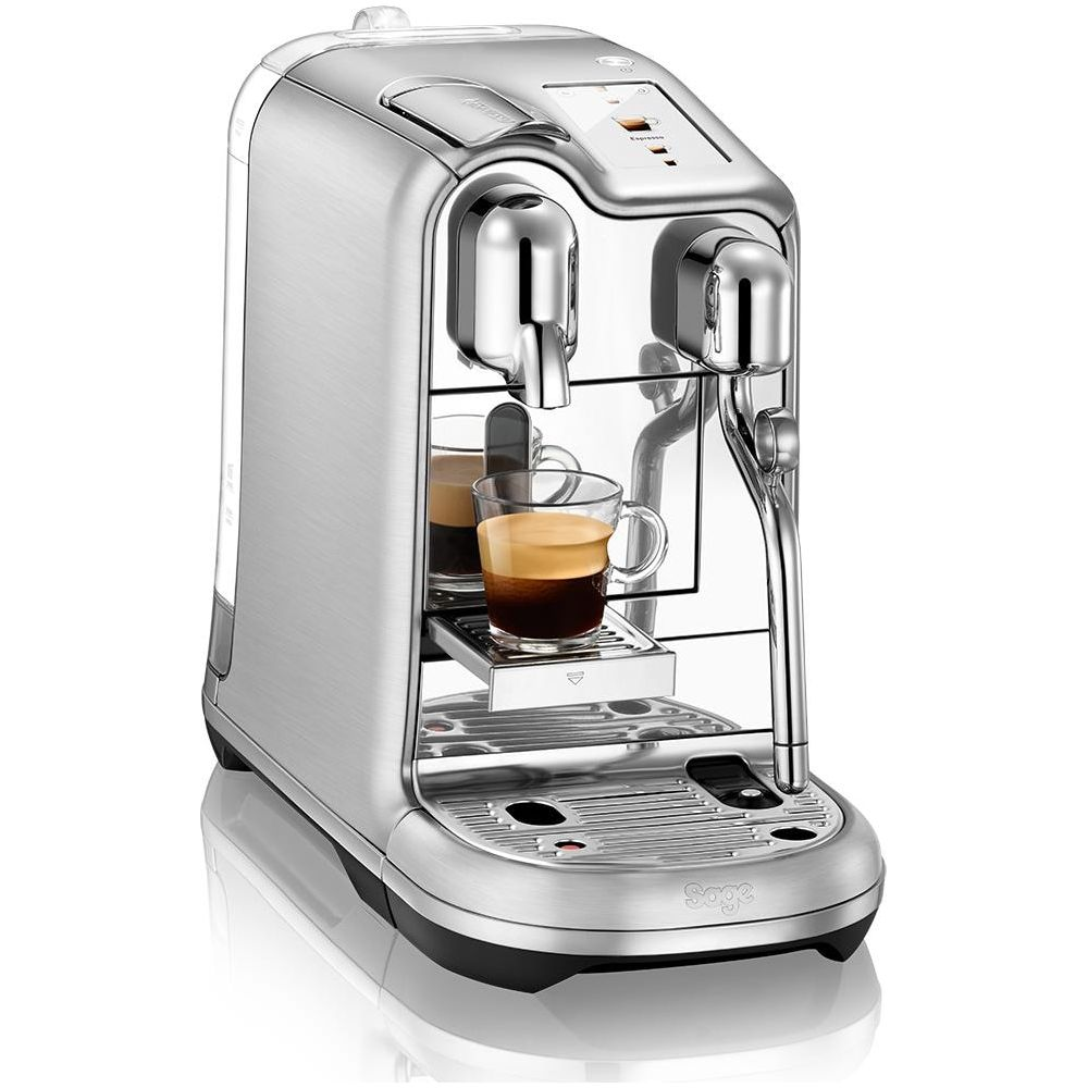 Una macchina da caffè argentata con un bicchiere di espresso.