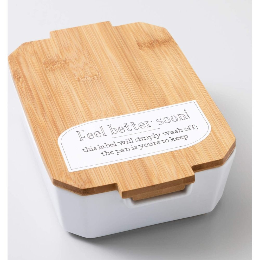 Weiße Lunchbox mit Bambusdeckel und Aufkleber "Fühl dich bald besser!"