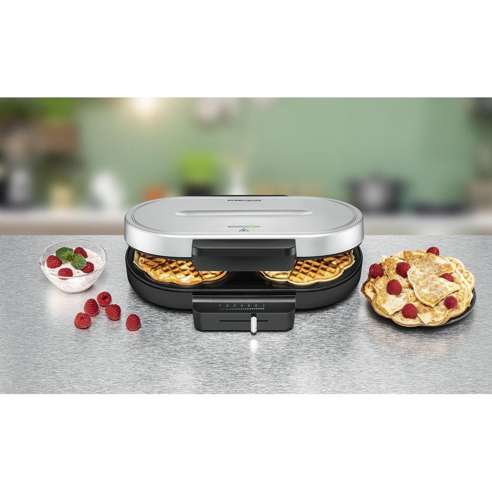 Srebrna gofrownica z gotowymi goframi, jagodami i jogurtem.