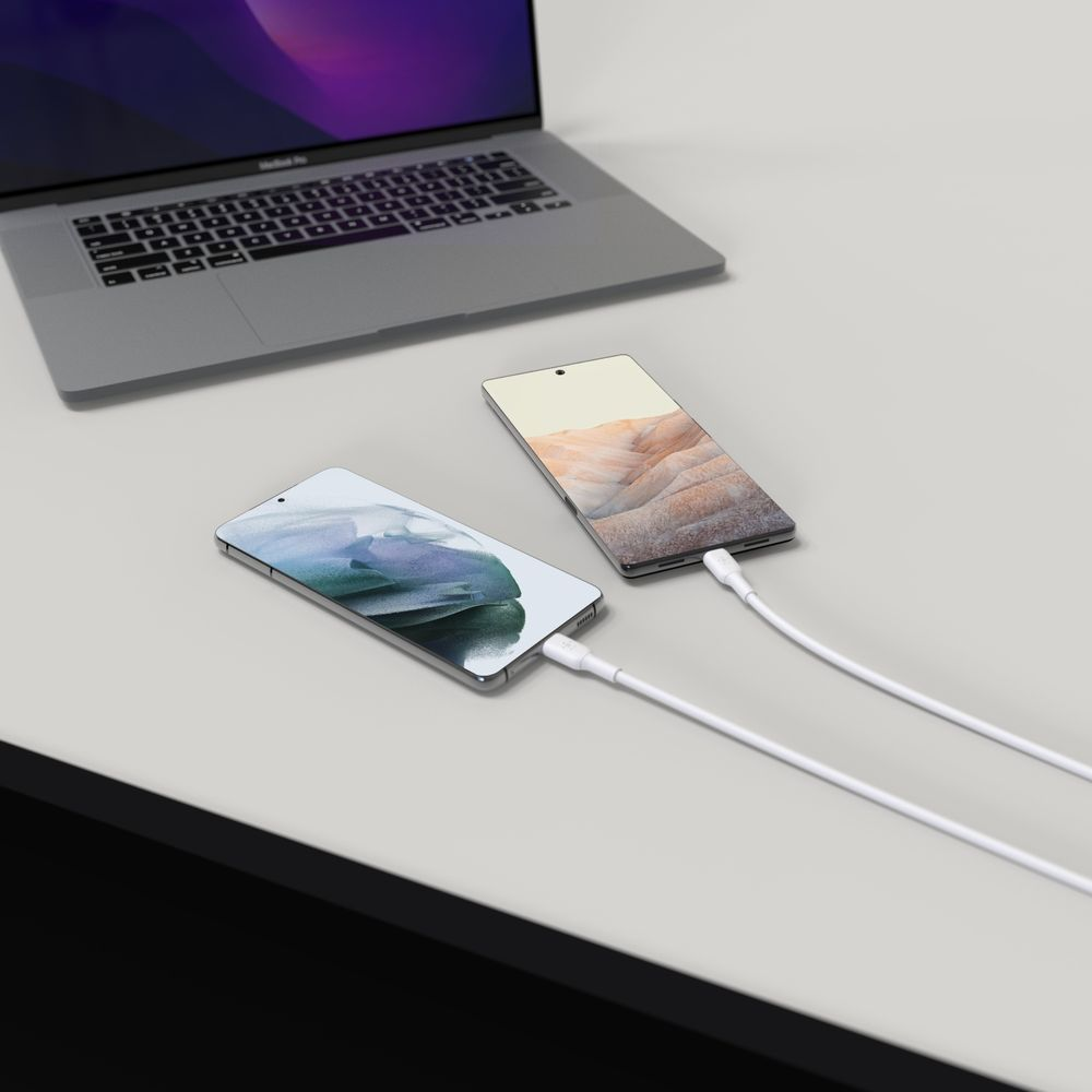 A laptop and two smartphones are connected on a desk.