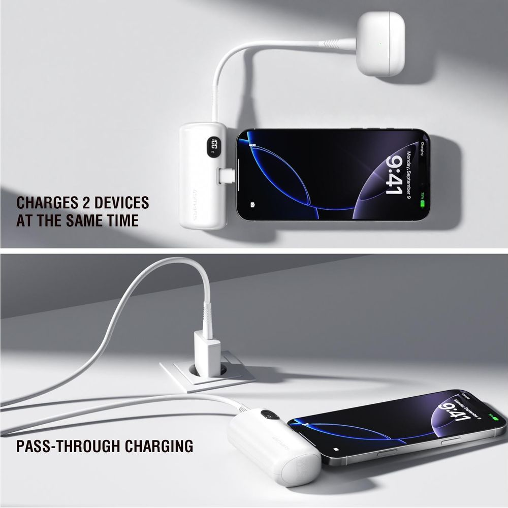 Un power bank bianco carica due telefoni. Uno è collegato, l'altro si carica tramite presa a muro.