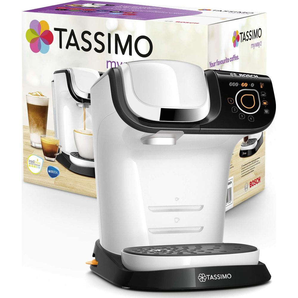 Biały ekspres do kawy Tassimo z czarnym panelem sterowania stoi przed opakowaniem.