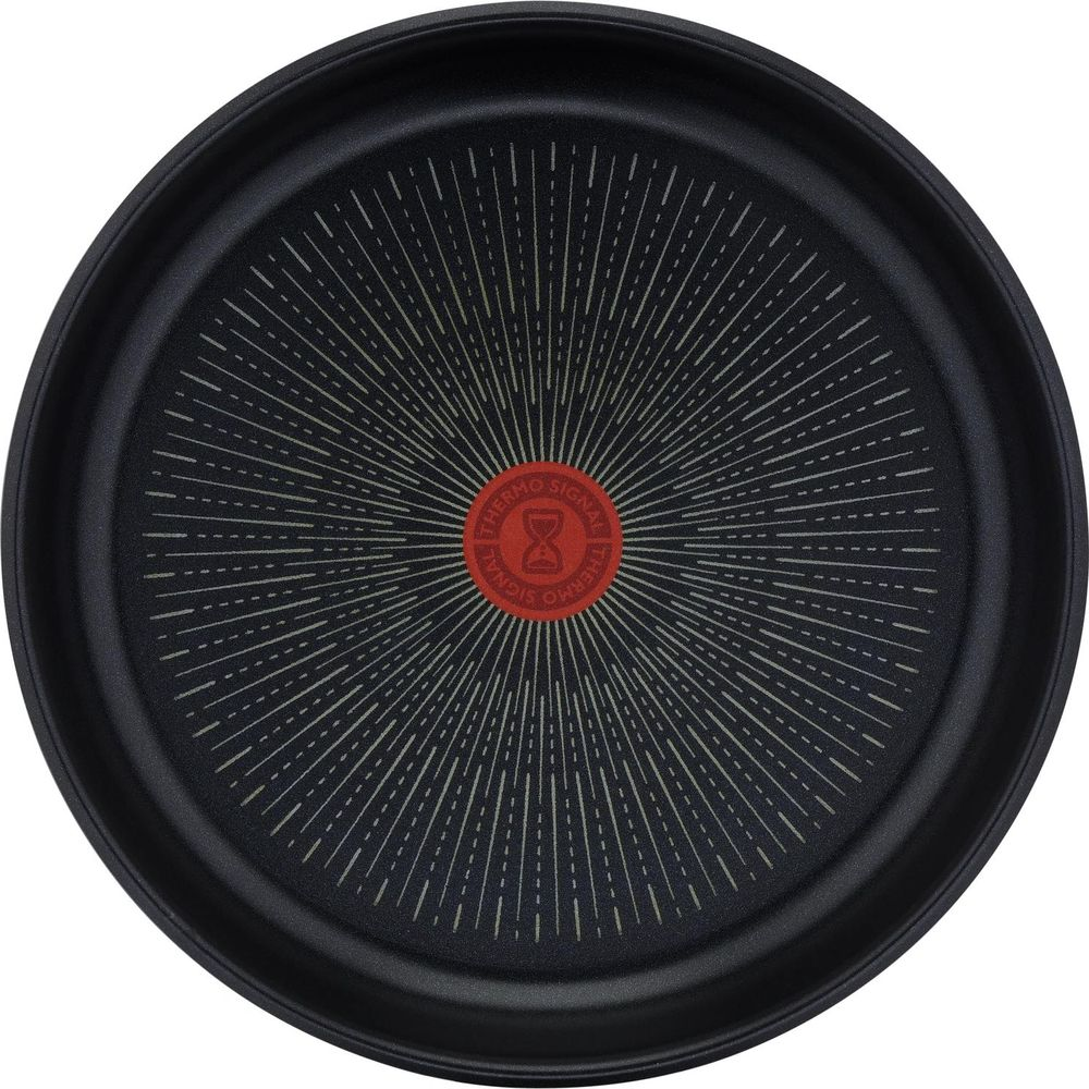 Poêle noire avec un indicateur rouge Thermo-Signal au centre.