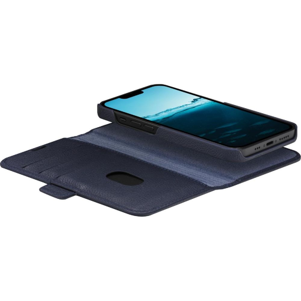 Uno smartphone blu poggia su una custodia a portafoglio blu scuro aperta con slot.