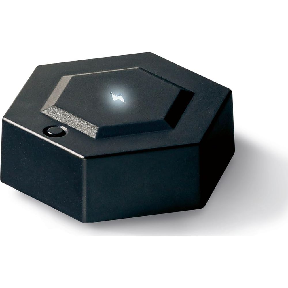 Un dispositivo nero esagonale con un simbolo luminoso sulla superficie superiore.