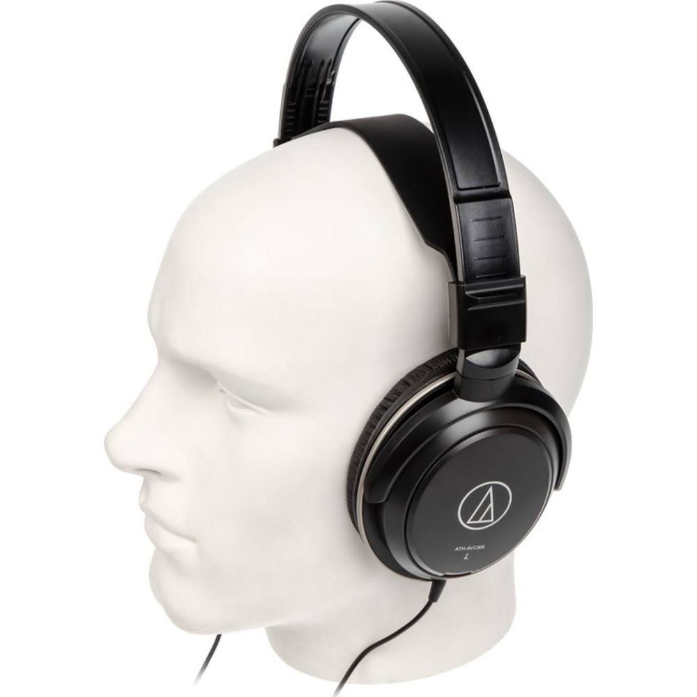 Czarne słuchawki nauszne z wyściełanym pałąkiem na białym manekinie.