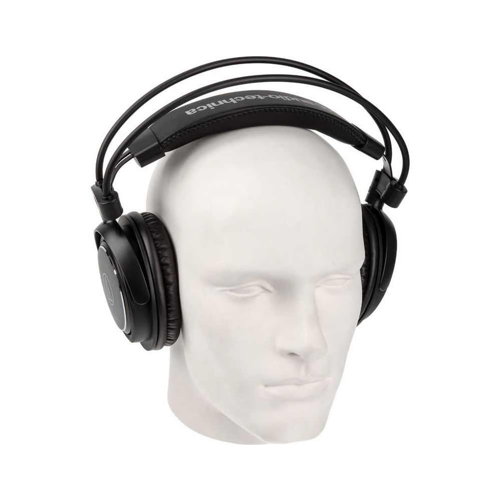 Cuffie nere over-ear con archetto imbottito su testa di manichino bianca.