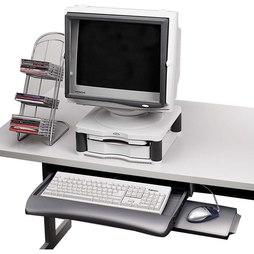 Una vecchia configurazione di computer con monitor, tastiera, mouse e porta CD.