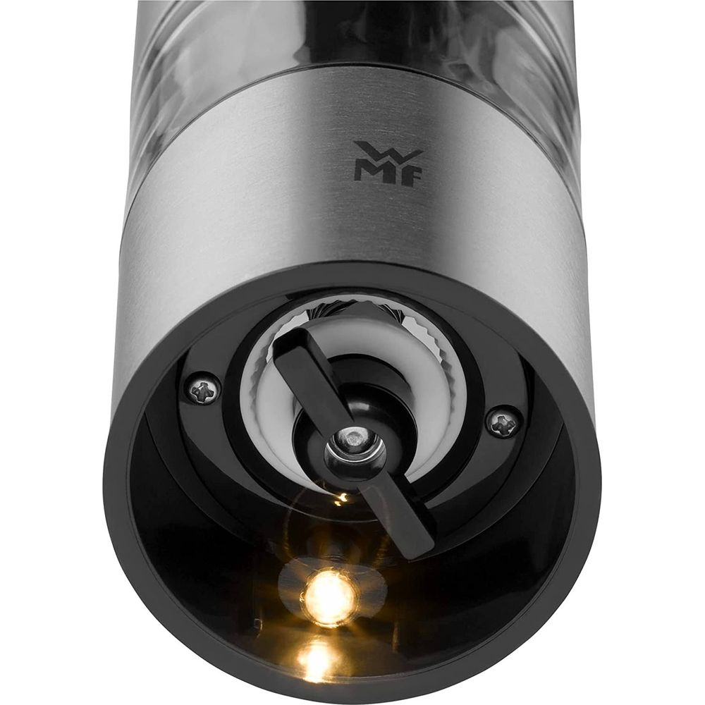 Nahaufnahme eines elektrischen Pfeffermühlenkopfes mit Metallgehäuse und Licht.