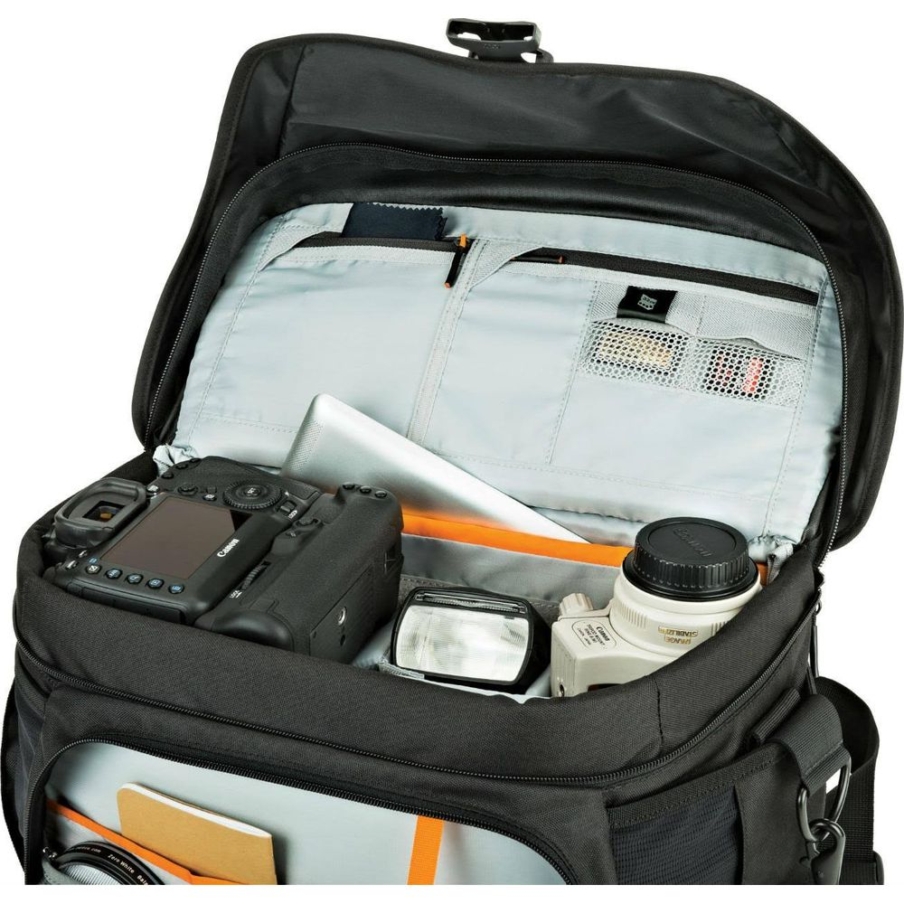 A black camera bag with a camera, flash, lens, and accessories inside.