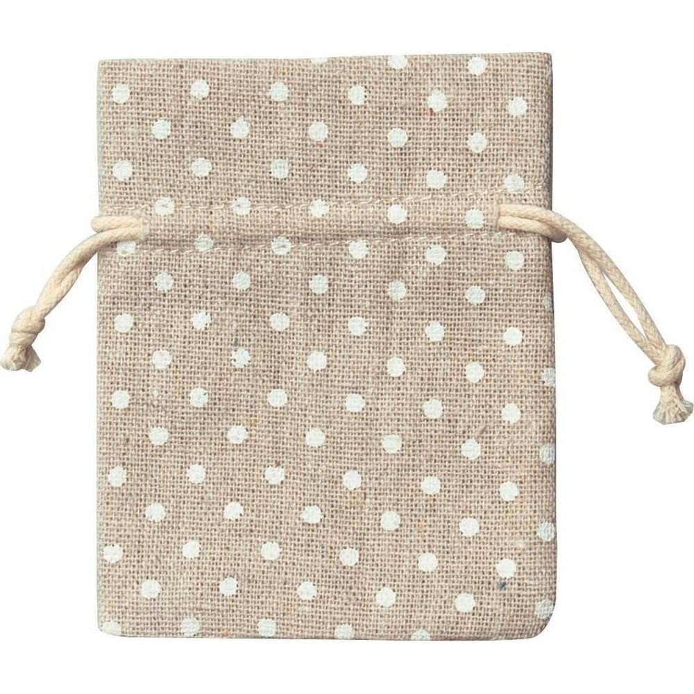Beżowa torba na sznurek w białe kropki.