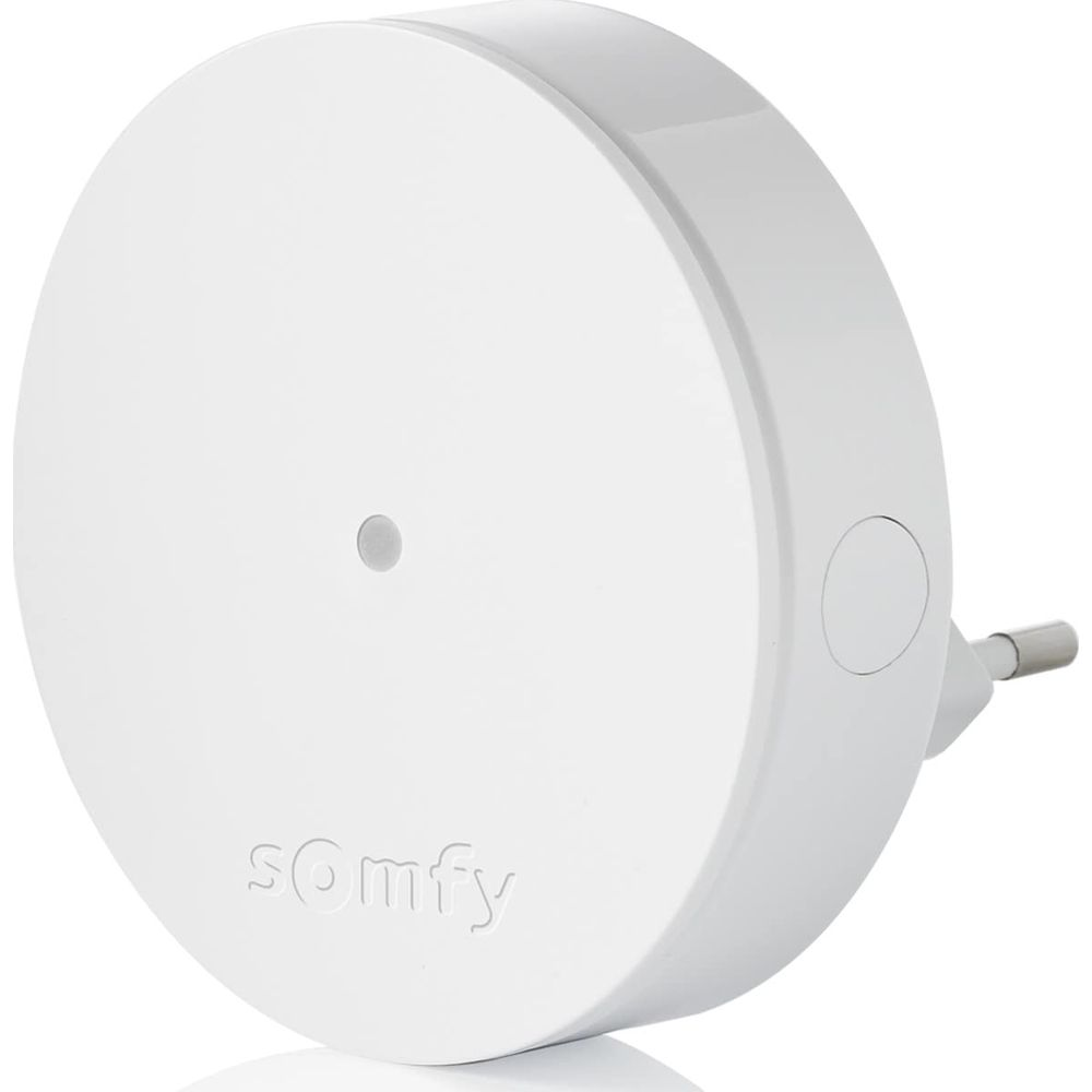 Ein weißes Somfy-Gerät mit einem kleinen grauen Punkt und einem Stecker.
