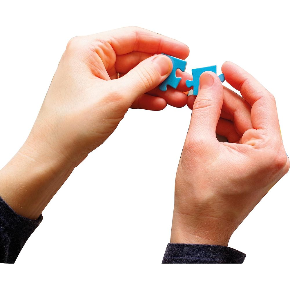 Two hands connecting two blue puzzle pieces.