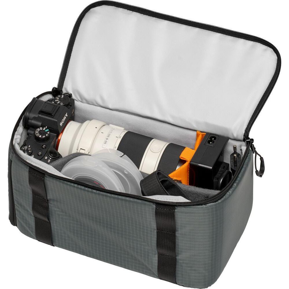 Grey camera bag with Sony camera, lens, and accessories inside.