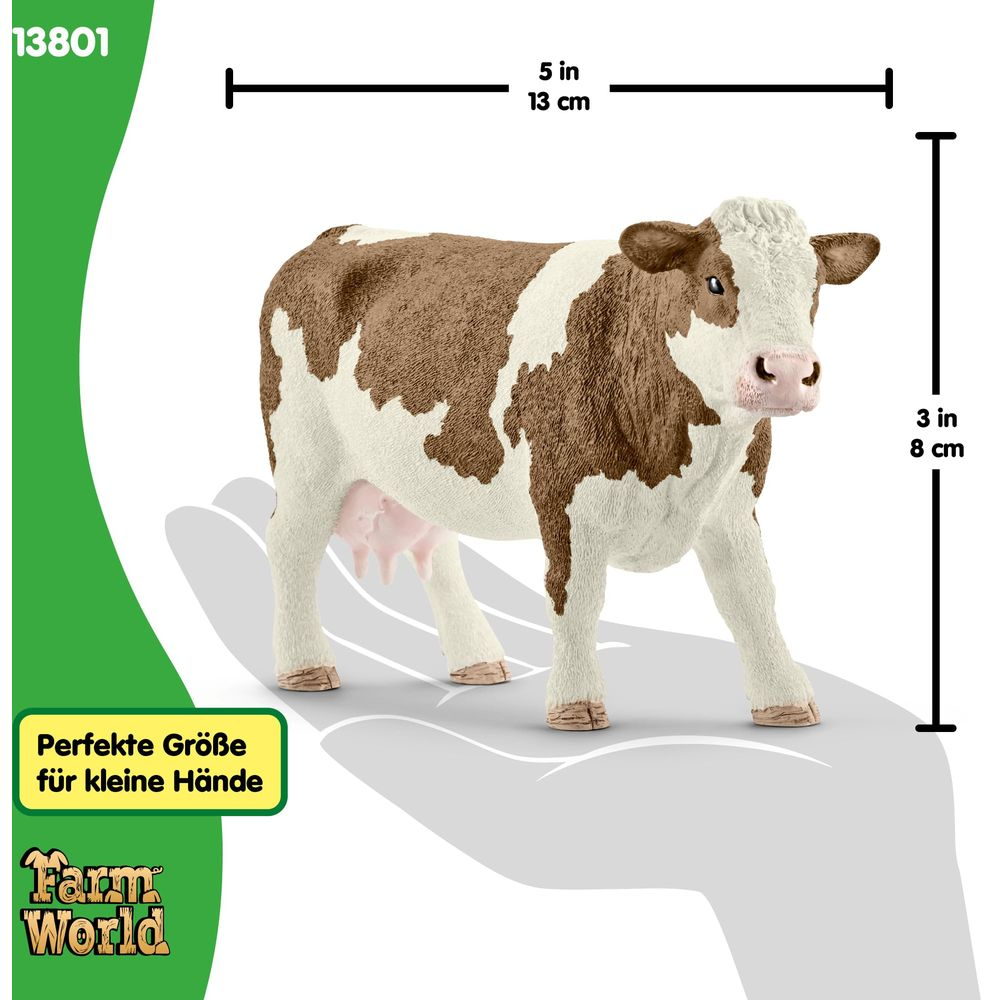 Brązowo-biała figurka krowy ze wskaźnikami rozmiaru 13 cm i 8 cm.