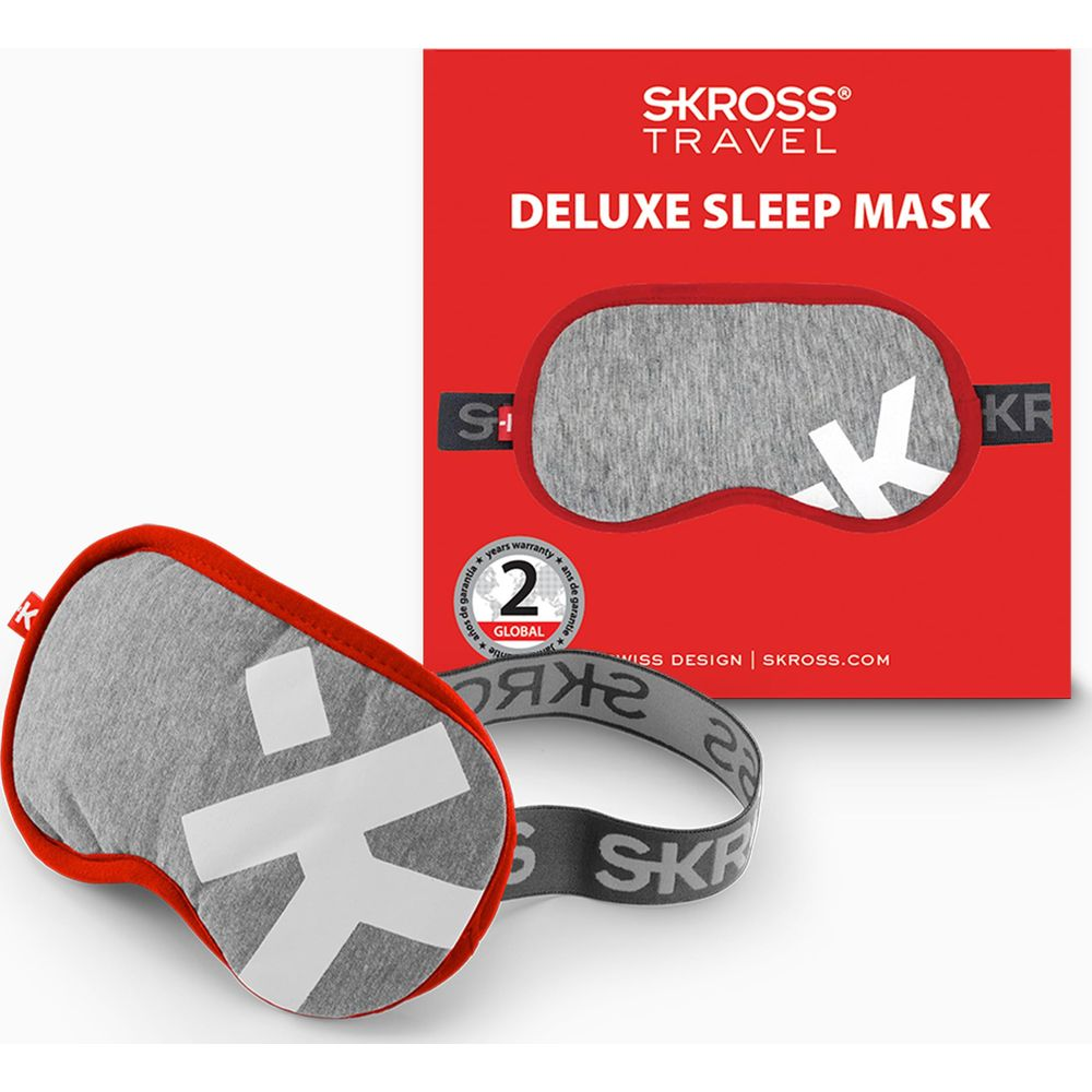 Maschera per dormire grigia con bordo rosso e logo K bianco, accanto alla confezione.
