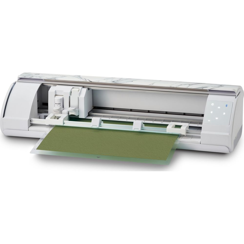 Ein weißer Schneideplotter mit Marmormuster-Oberseite und grünem Papier.