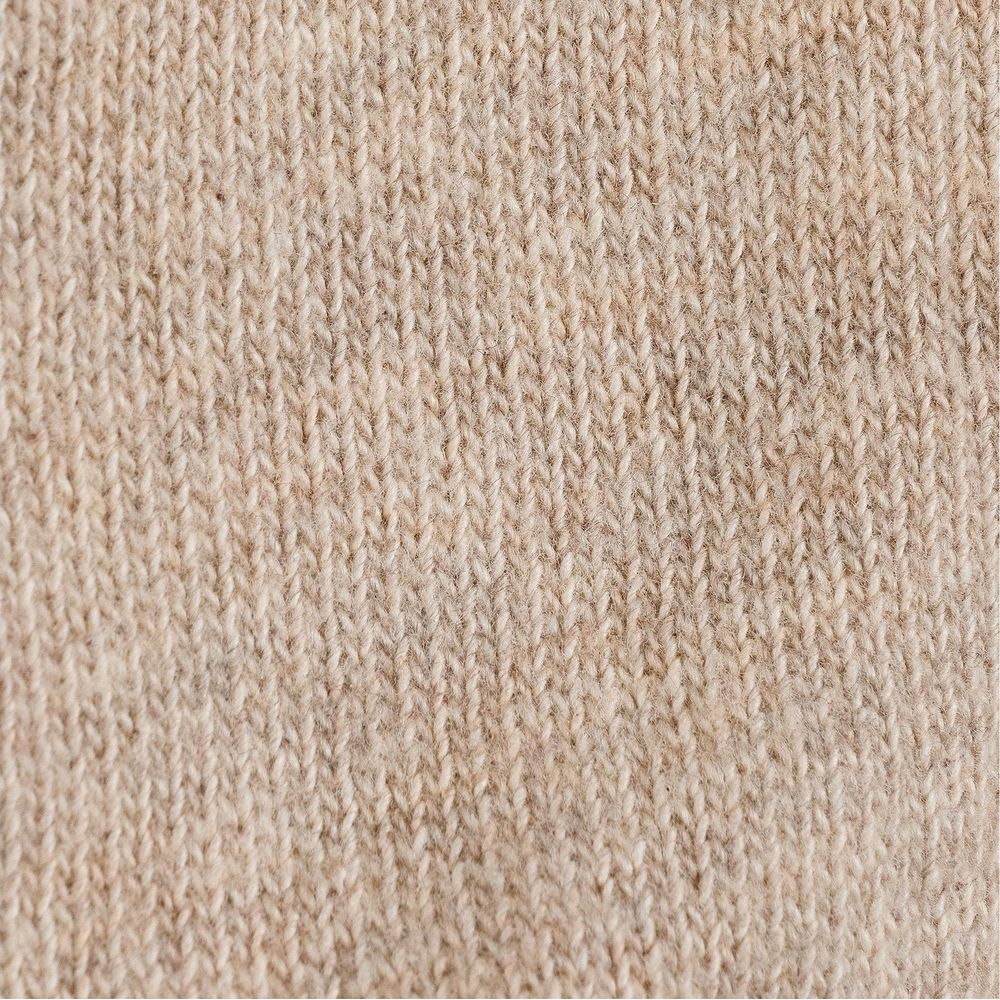 Primo piano di una trama a maglia marrone chiaro con fibre sottili.