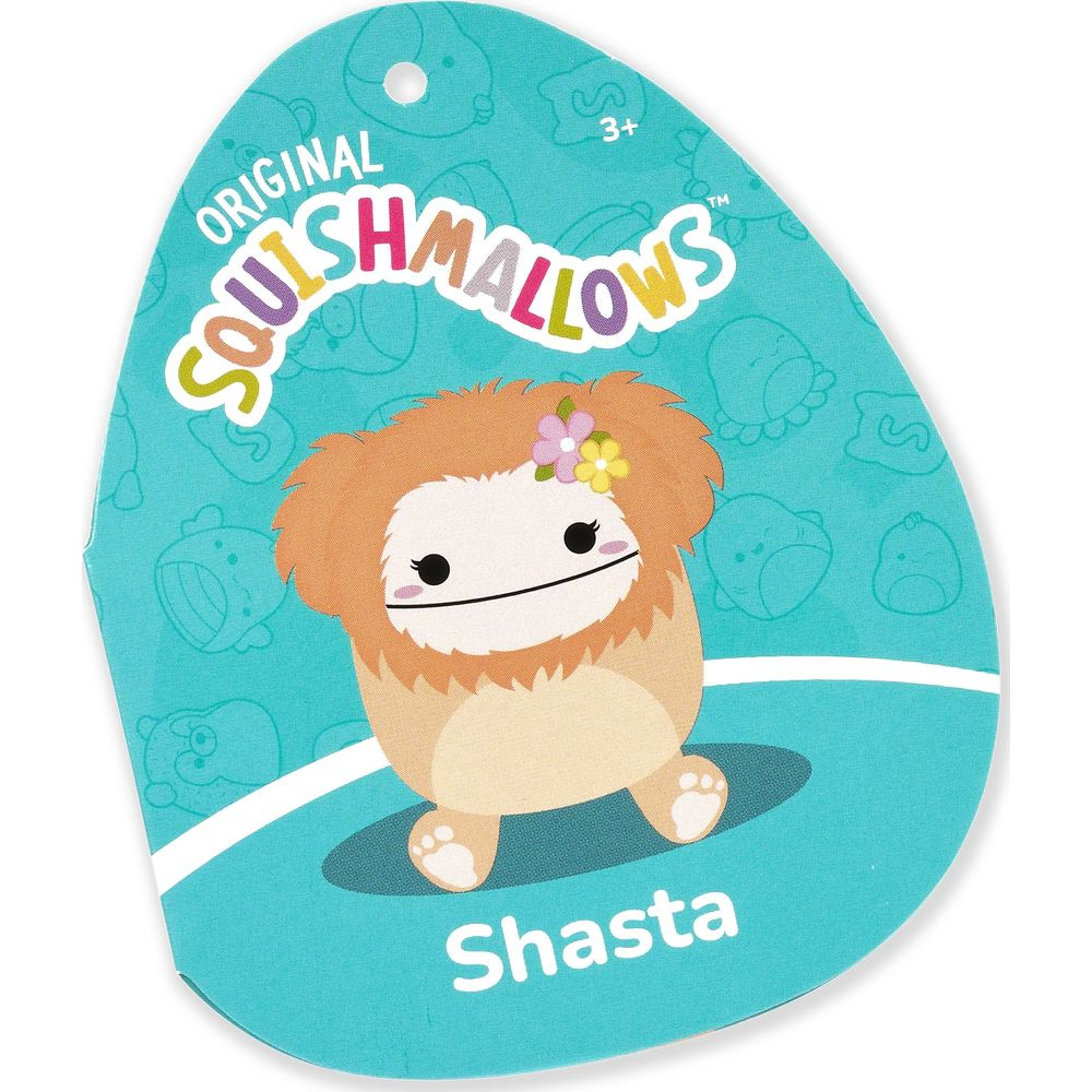 Un personnage Squishmallow nommé Shasta avec de la fourrure orange et des fleurs dans les cheveux.