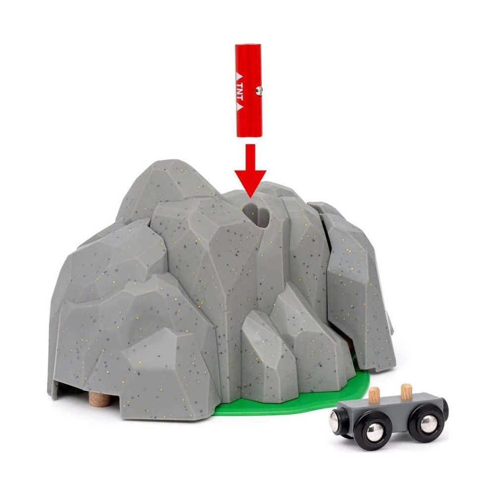 Zabawkowy pociąg i szara jaskinia skalna z czerwoną laską TNT.