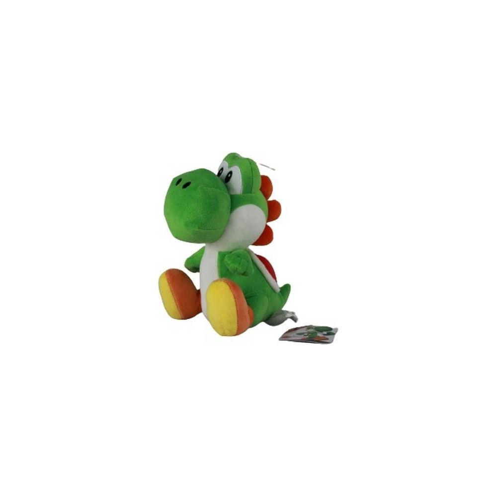 Une peluche Yoshi verte aux pieds oranges et aux pointes rouges est assise.
