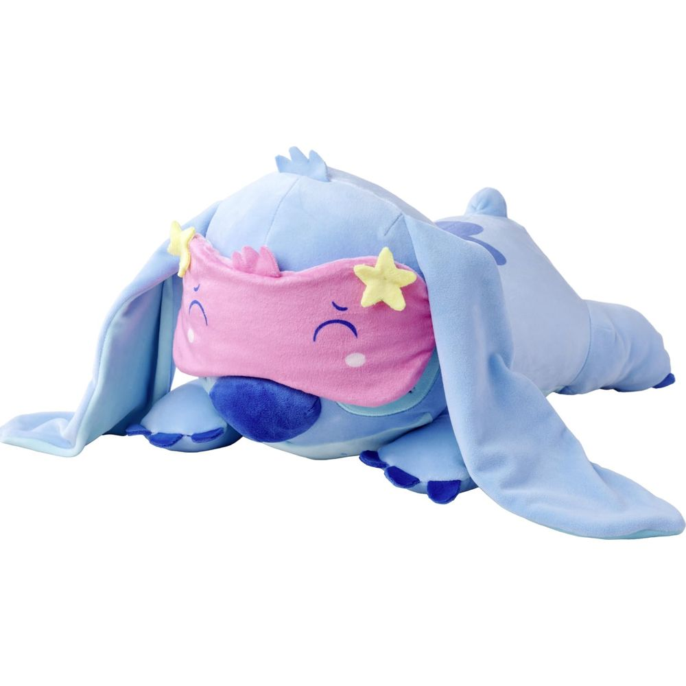 Ein blauer Stitch-Plüsch mit rosa Schlafmaske mit Sternen und traurigen Augen.