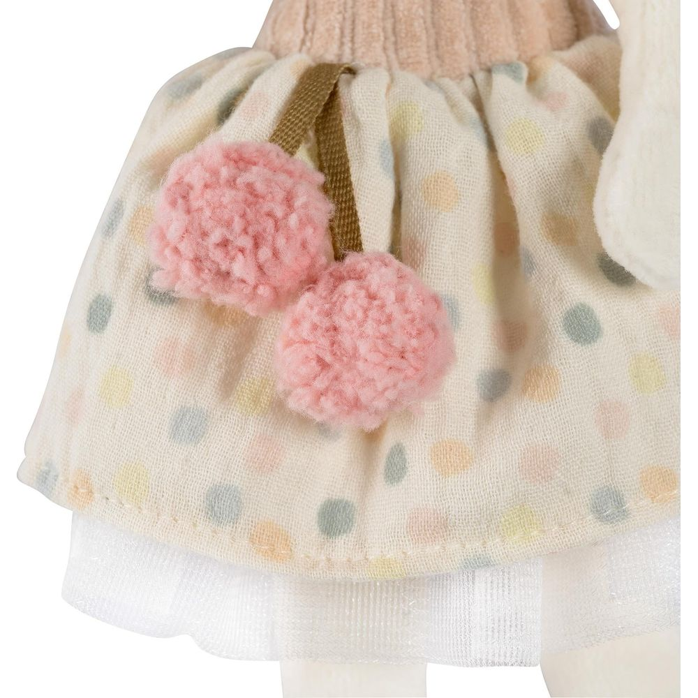 Un peluche con gonna a pois, pompon rosa e biancheria intima bianca.