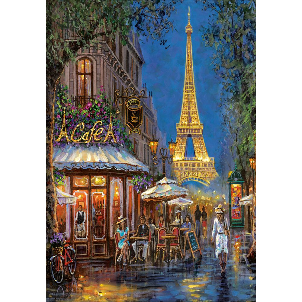 Pariser Café-Szene bei Nacht mit dem beleuchteten Eiffelturm im Hintergrund.