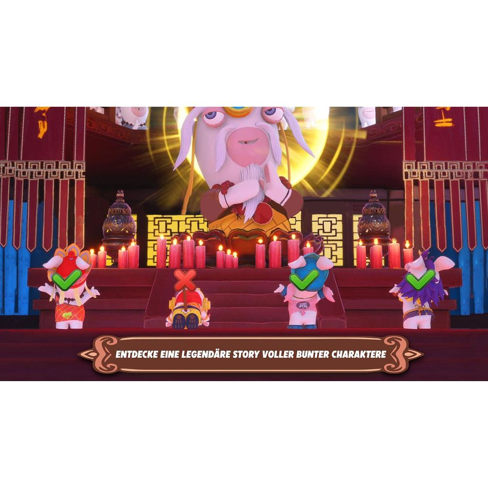 Vier Rabbids in bunten Kostümen stehen vor Kerzen und einem großen Rabbid-Orakel.