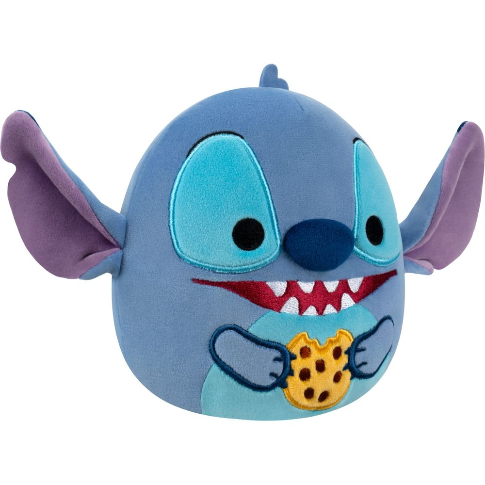 Ein blauer Stitch-Plüsch hält einen Keks. Er hat große Augen und einen breiten Mund.