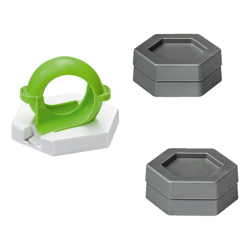 Zielony i biały spinner do zabawy z dwoma szarymi sześciokątnymi pojemnikami.