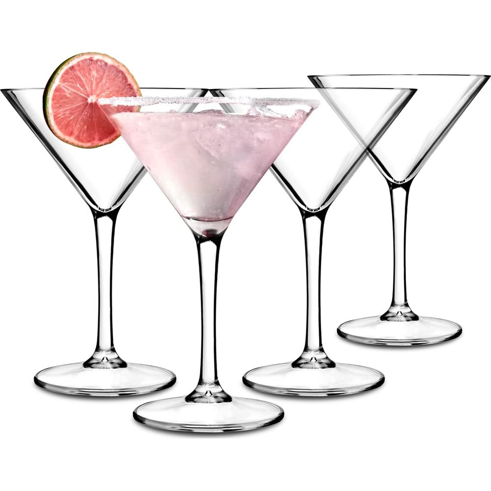 Four martini glasses on white, one with a pink drink and lime slice garnish.