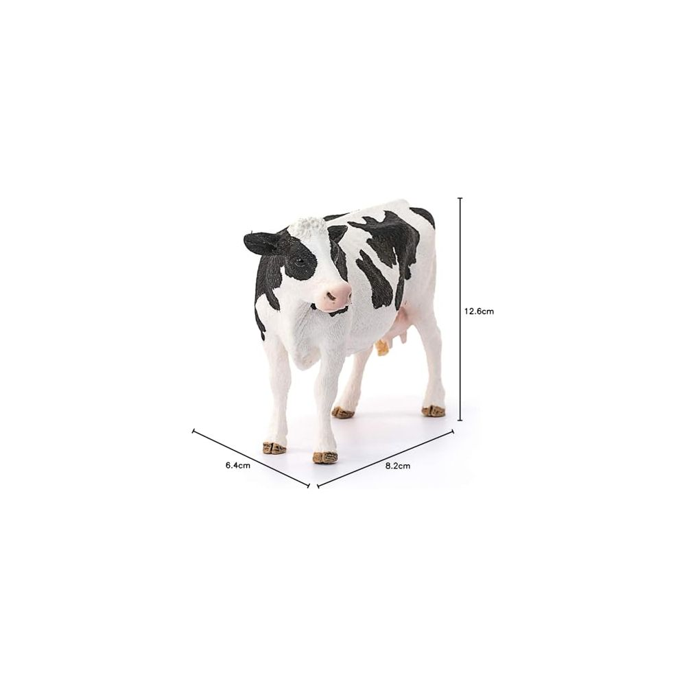 Una statuetta di mucca bianco e nero su sfondo bianco, con dimensioni.