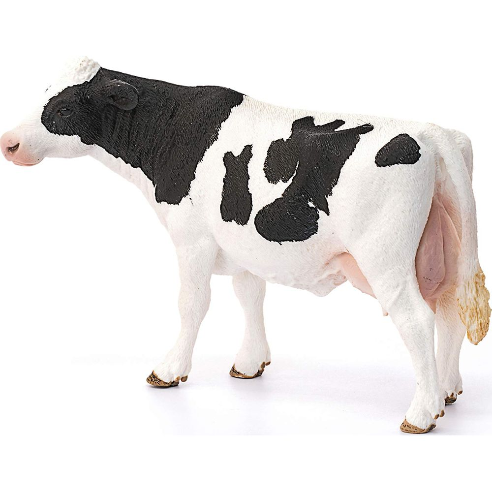 Una mucca bianco e nero sta di lato con dettagli di pelliccia.