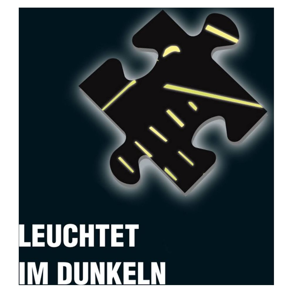 Czarny element układanki z żółtymi liniami świeci w ciemności.